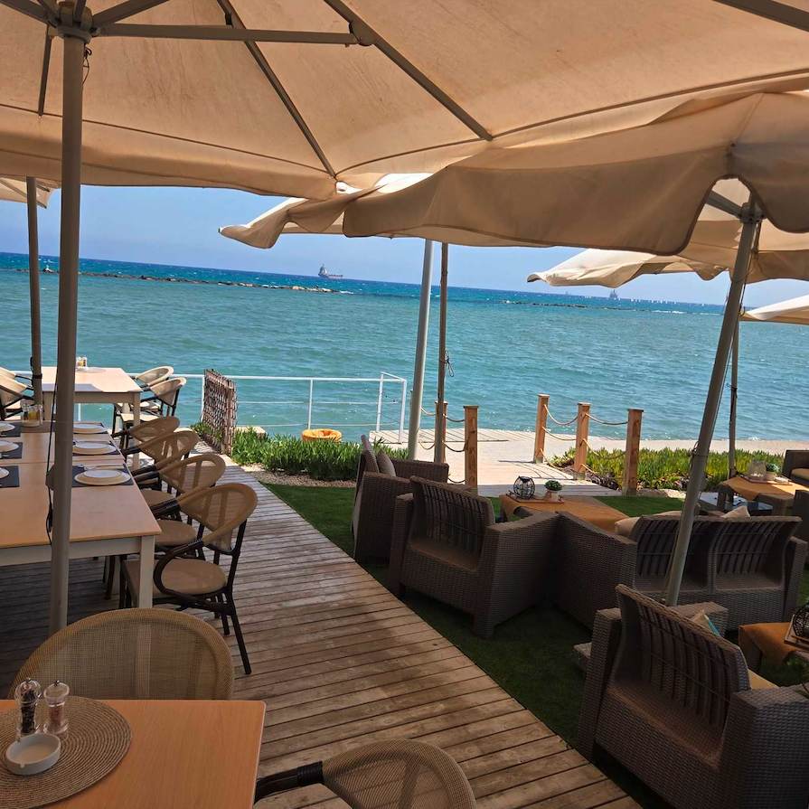 The terrace lounge and deck beside the sea at dusk