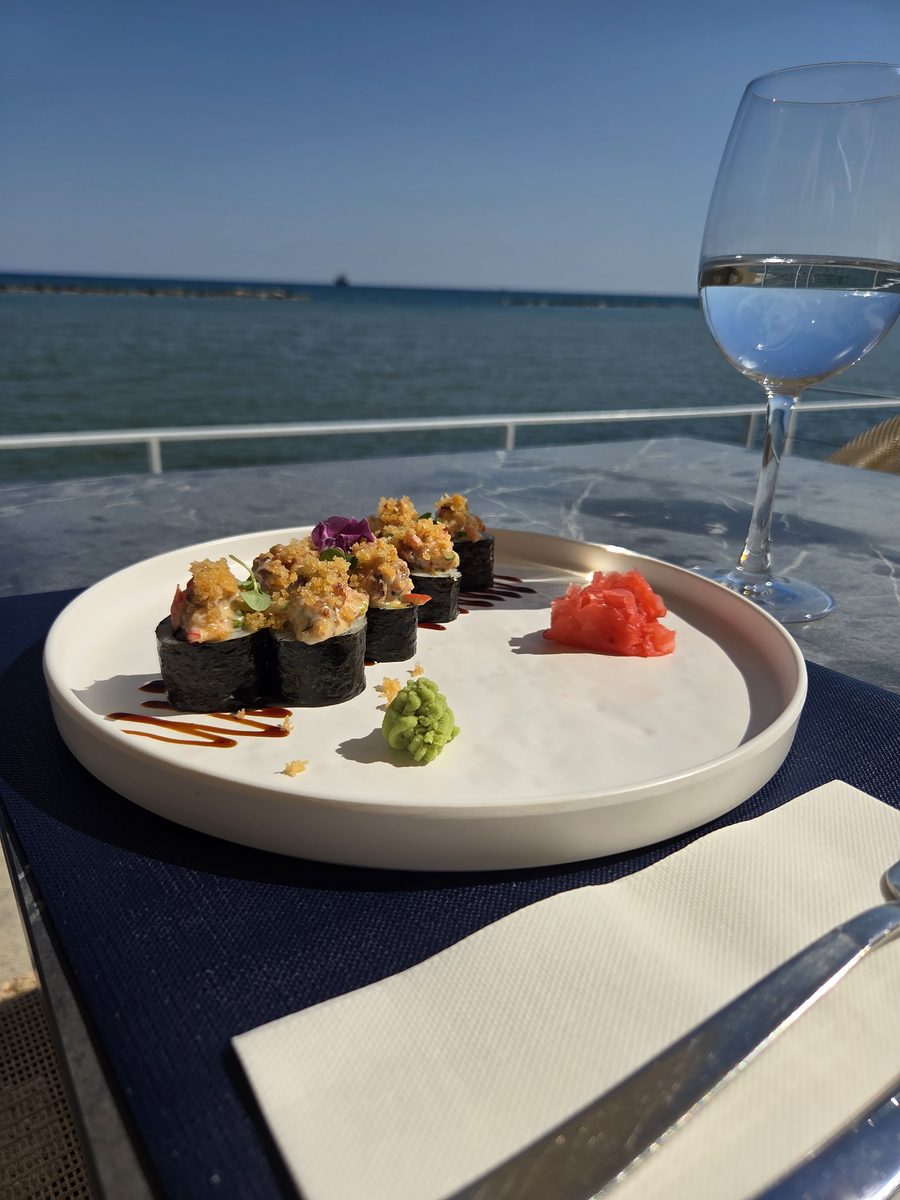 Sushi and a glass by the sea